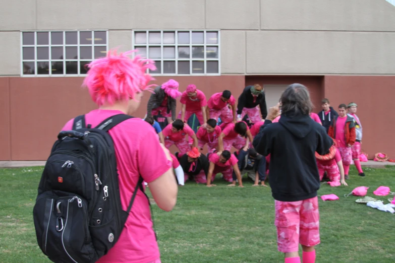 a person in pink pants is facing away from a group of women