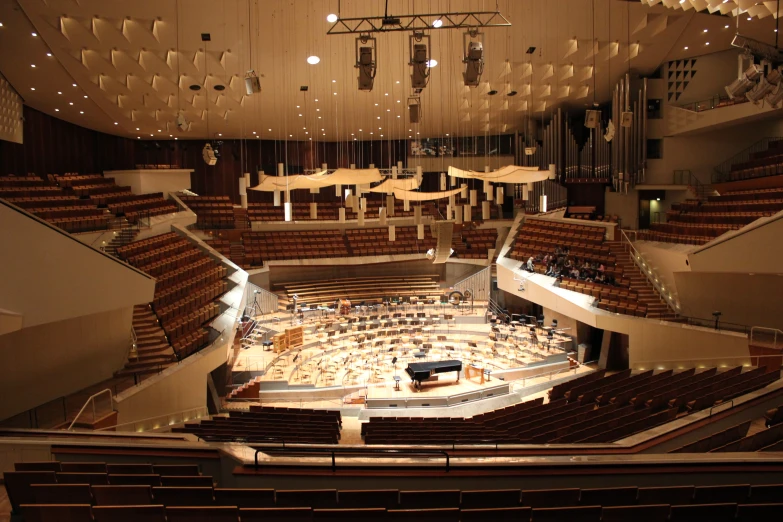 a concert hall that includes several seats with a concert on the stage