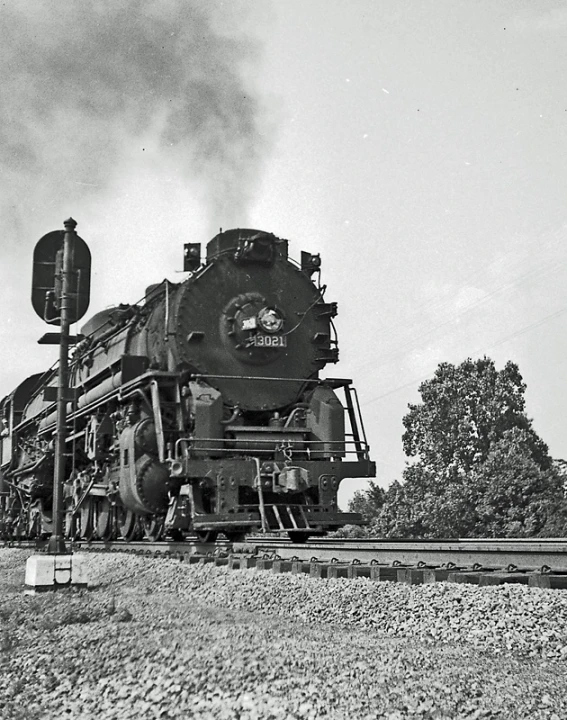 an old steam engine train moving along tracks