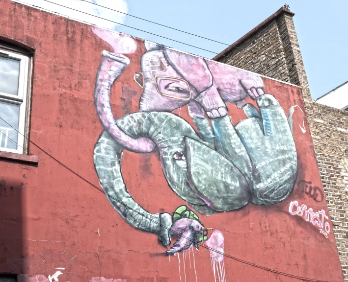 an elephant graffiti art work is on the side of a building