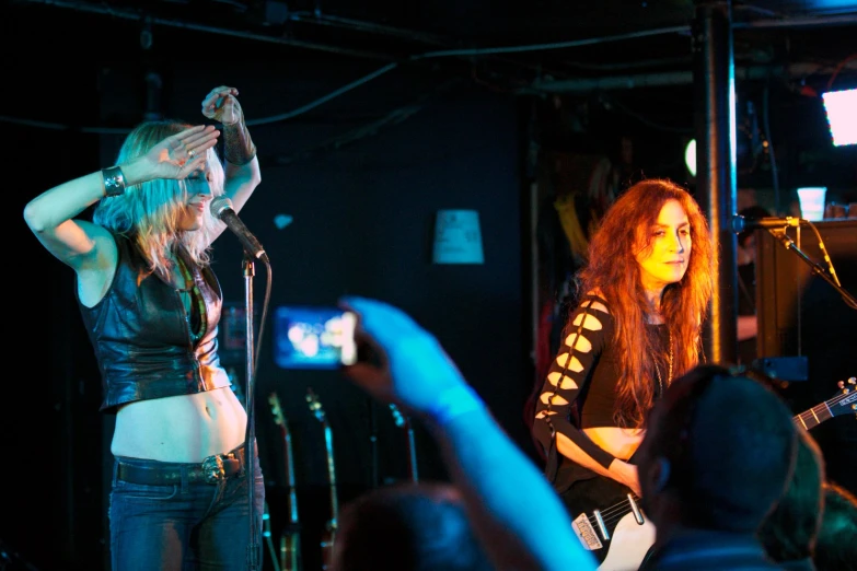 two girls standing next to each other in a room