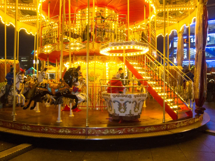 an amut park with horses and lights