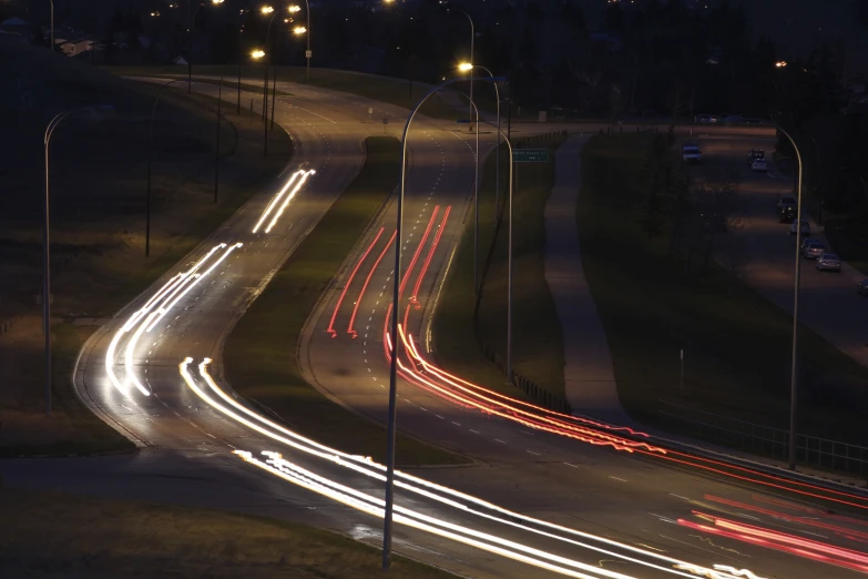 the lights of all different car trails streak through this street