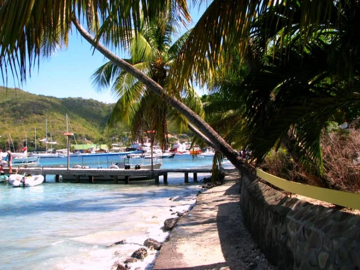 the boats are docked on the water by the pier