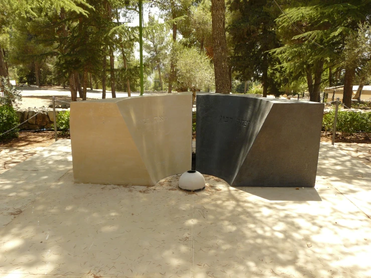 two black and grey blocks on a sidewalk