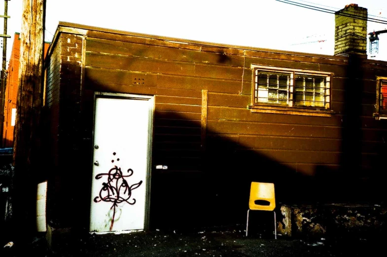 a yellow chair sitting in front of a building