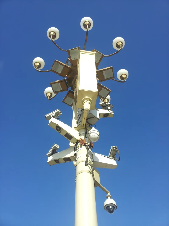 a very big lamp post with some lights and cameras