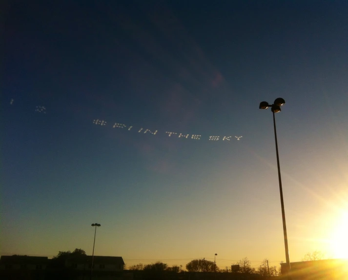 a plane is flying in the sky at sunset