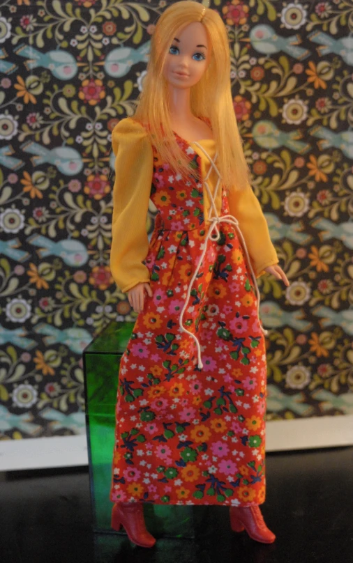 a doll is wearing a long dress and boots