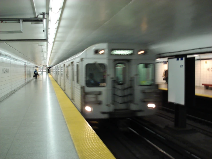 an underground subway station with moving train