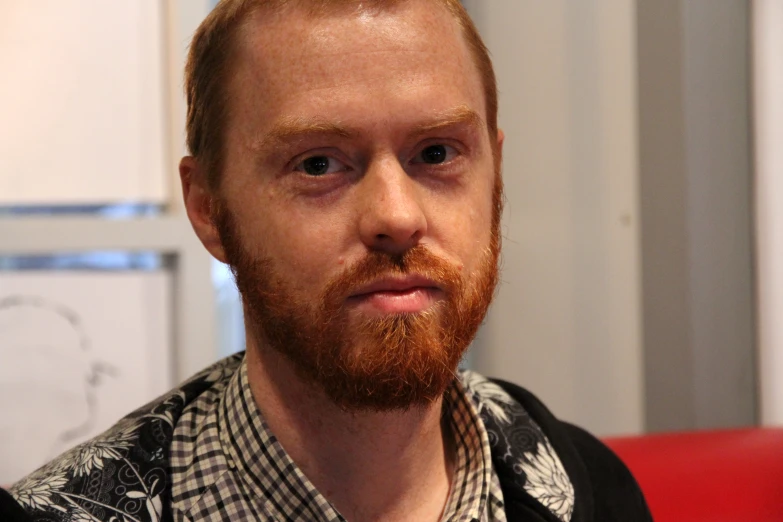 a man with red hair wearing black shirt