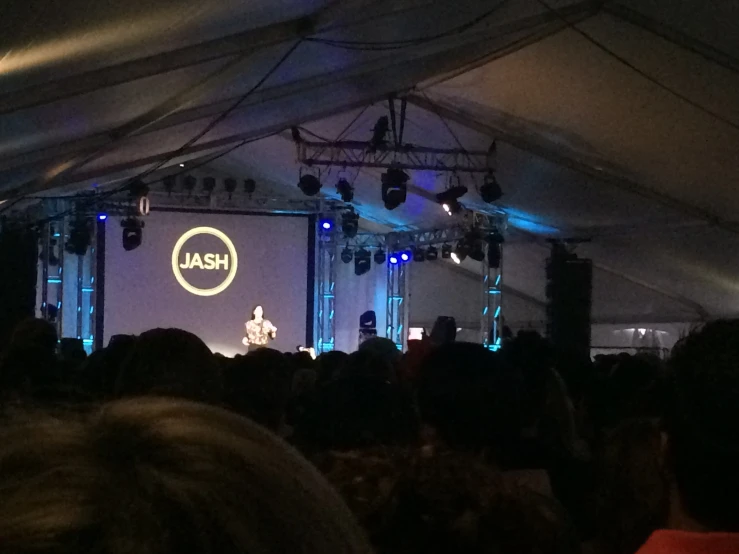 a stage set up with people watching soing on it