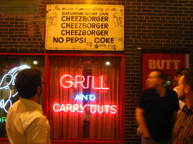 people standing in front of a business that sells food