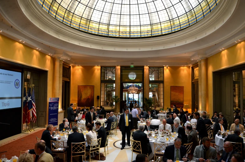 several tables with people sitting at round tables