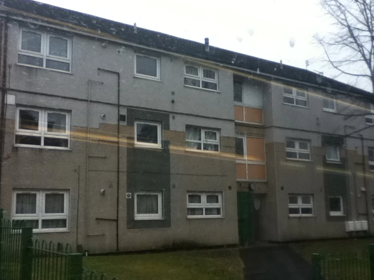 some windows are seen on a gray building