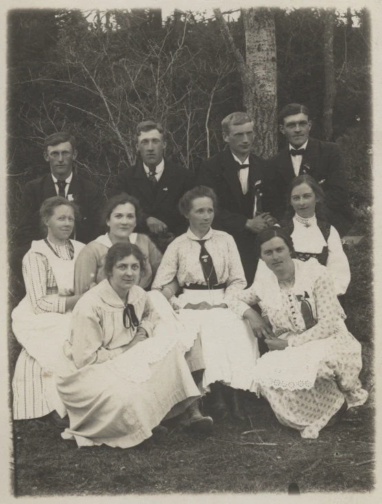 an old po of several women sitting in front of trees