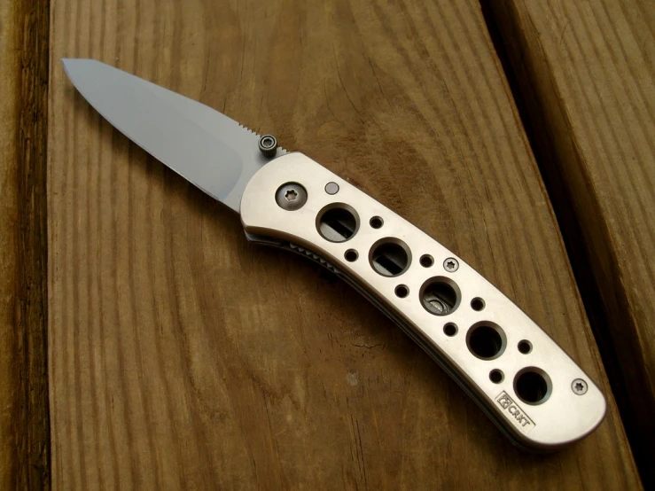 a knife sitting on top of a wooden table