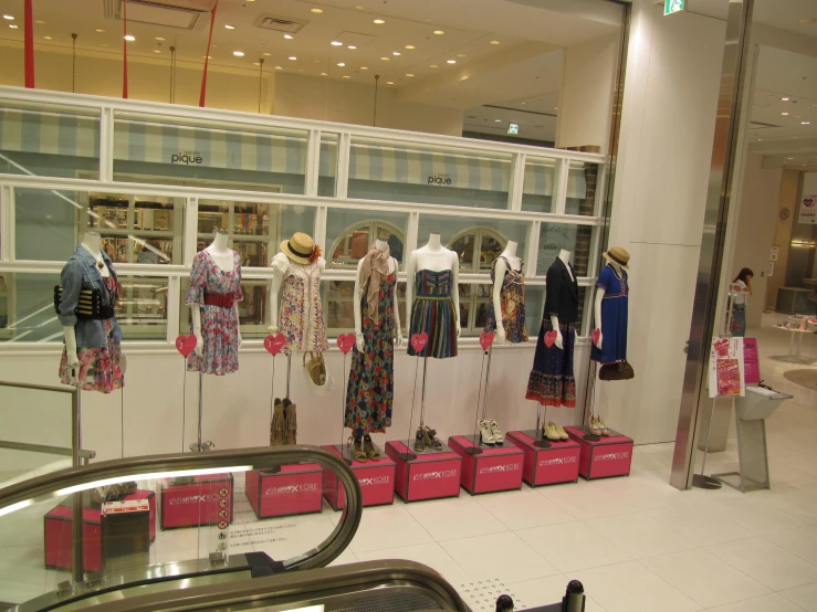a women's clothing store with mannequins, and clothes