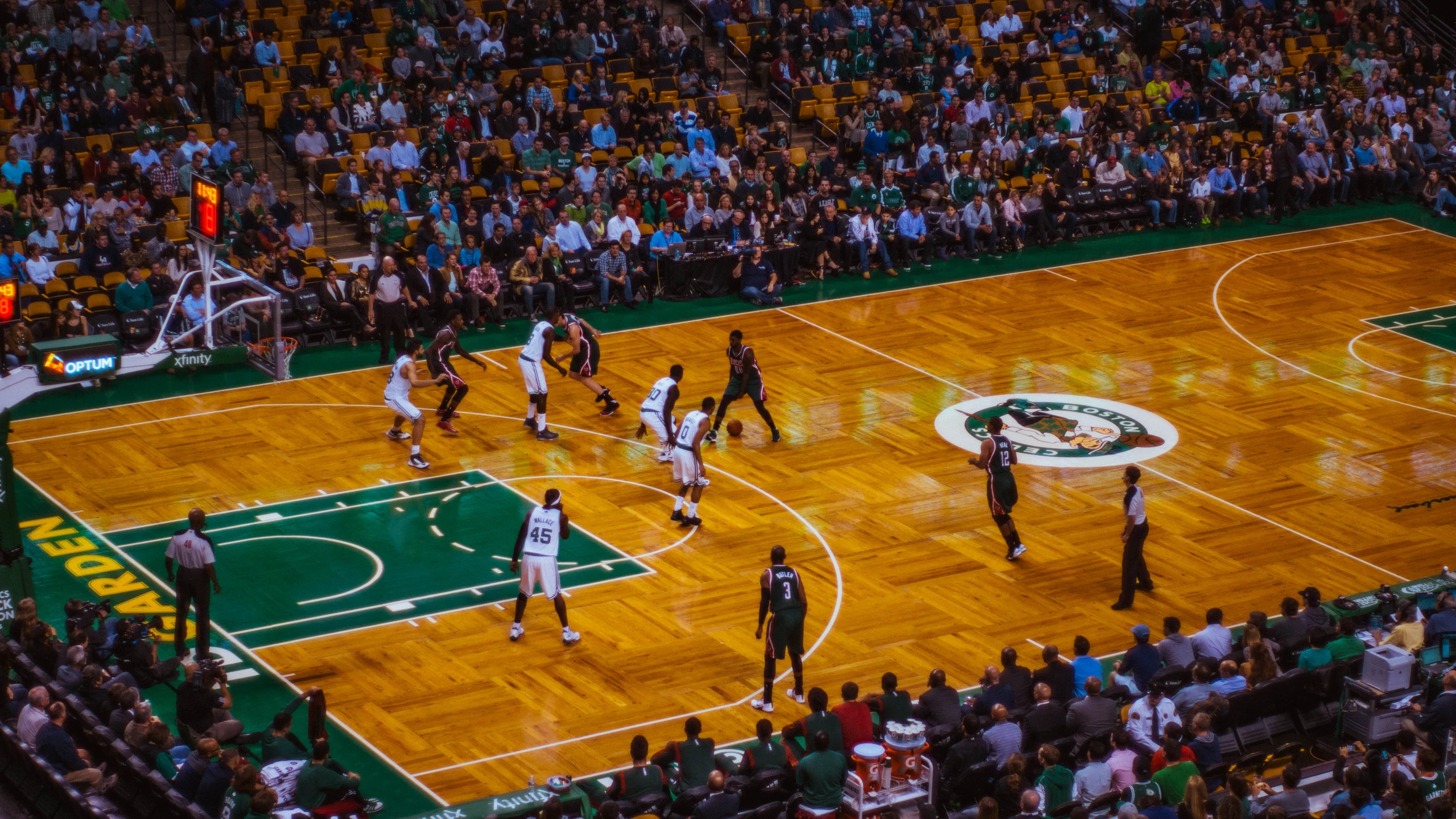 a basketball game played on a court while the crowd watches