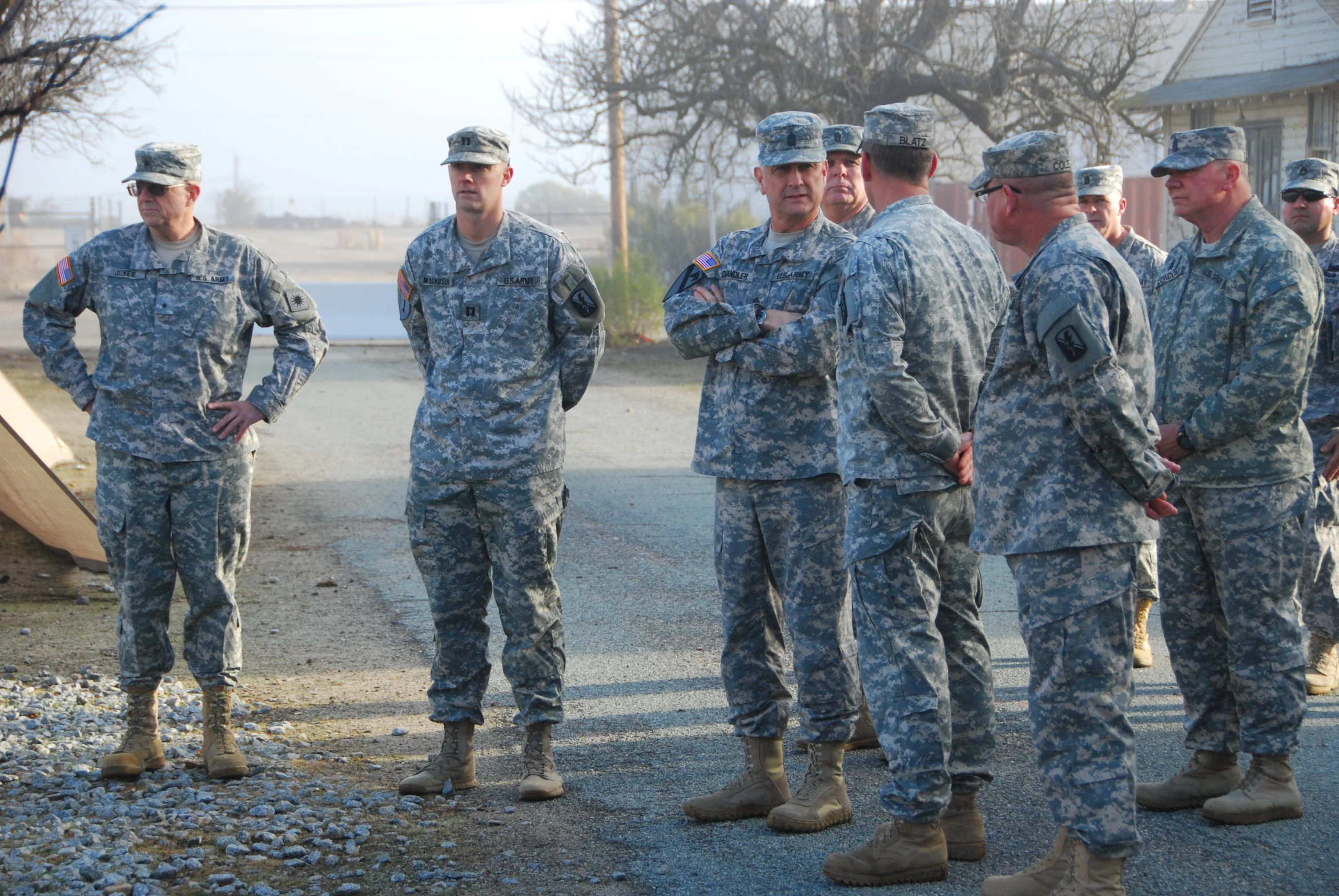 military men stand together and watch