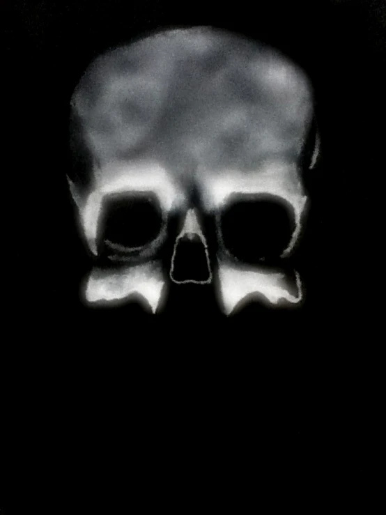 a skull with three black eyes on a dark background