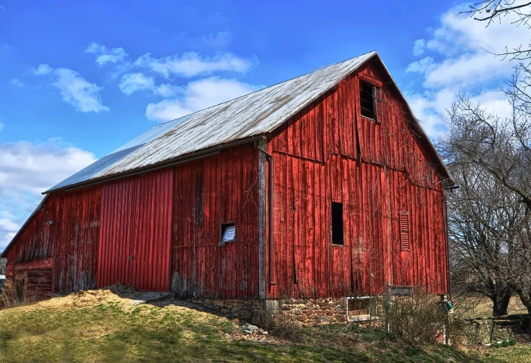 the barn is red and has many windows