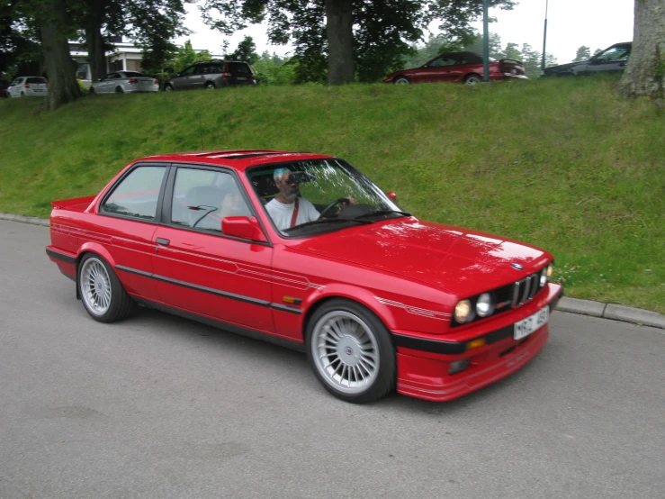 an image of a red car parked by itself