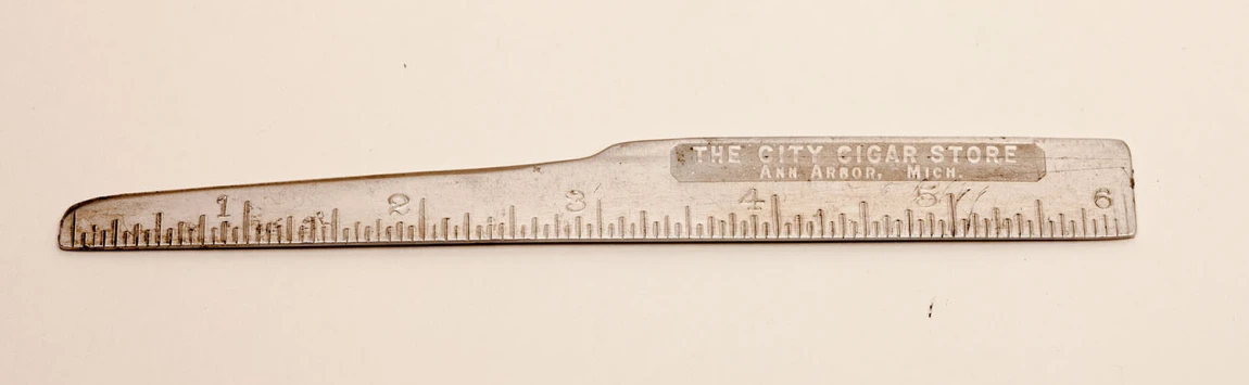 a metal ruler with an old, scratched - down surface