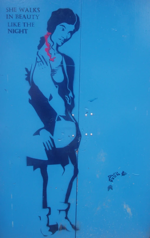 a blue wall has a painted woman on it