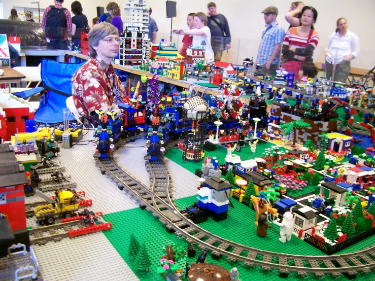 a lego town has people looking around it