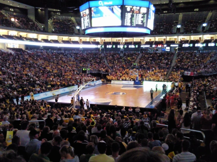 a full stadium with a basketball court and court stands