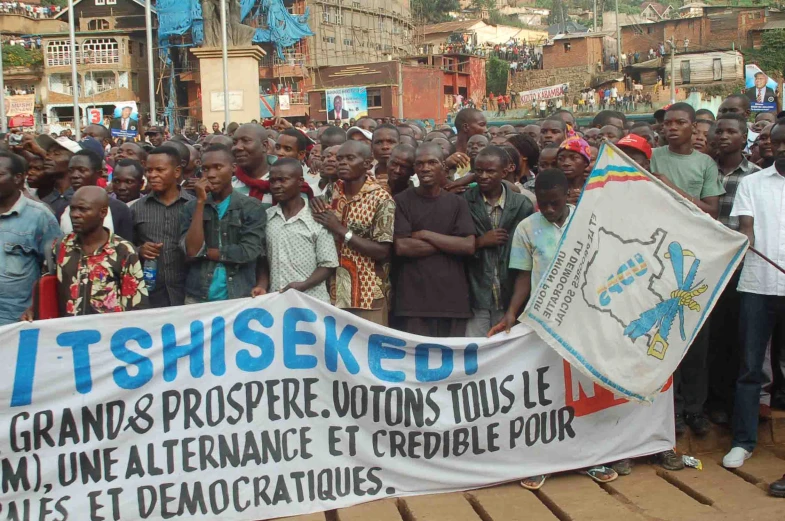 group of people in front of a banner with one woman on it