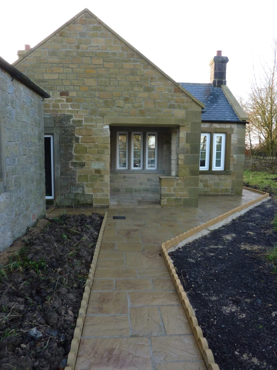 a small brick building with an empty path