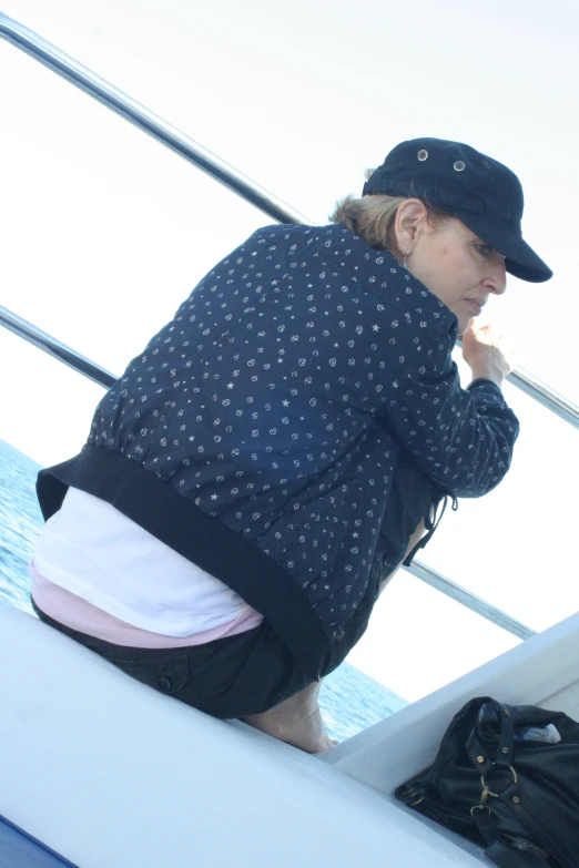 woman on ship observing water from deck of boat