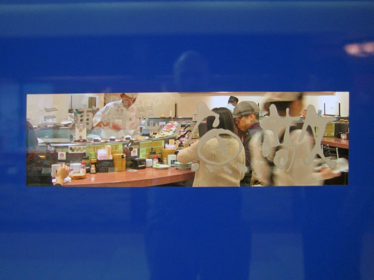 people and food in an indoor area with blue background