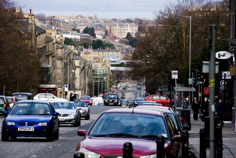 cars stopped in a crowded intersection on the side of a busy street