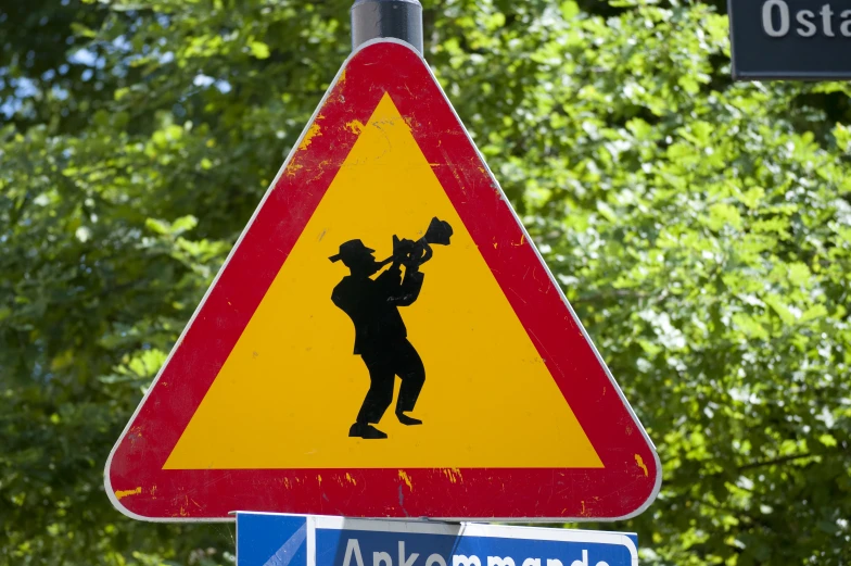 a street sign with a german style design and a man playing the trumpet