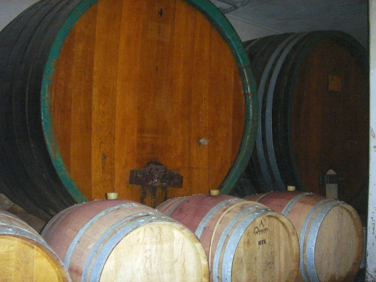 four wooden wine barrels in front of a wood door