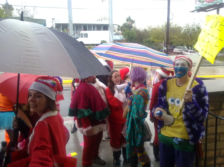 a group of people wearing colorful clothing in the rain