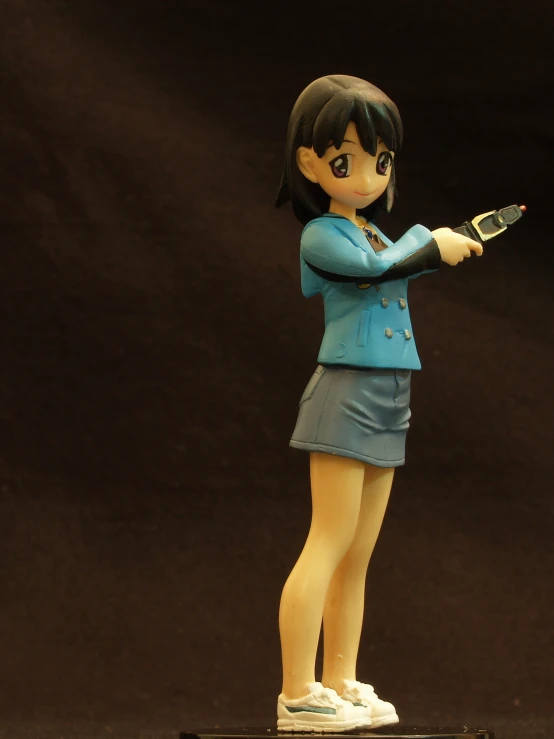 a girl figurine on a black surface