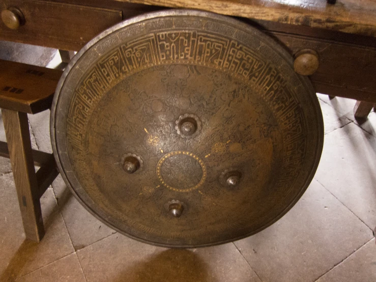 the metal bowl has several different symbols on it