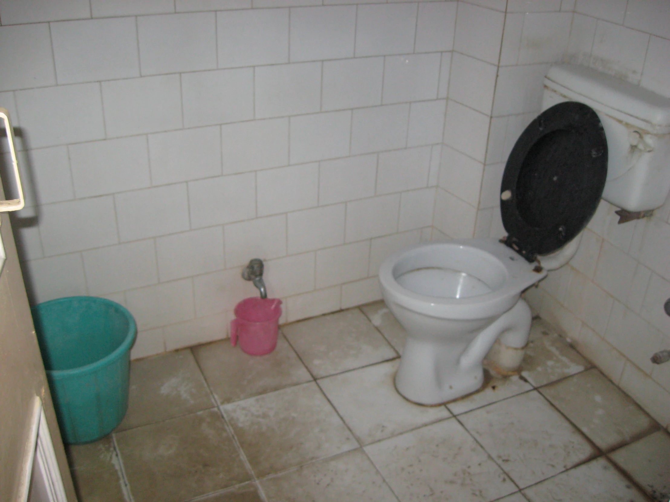 toilet bowl with dirty toilet in bathroom area