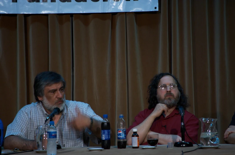 a group of people sitting at a table with bottles