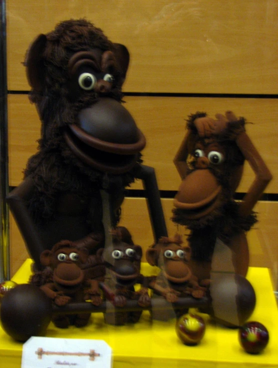some monkey figurines are lined up for display