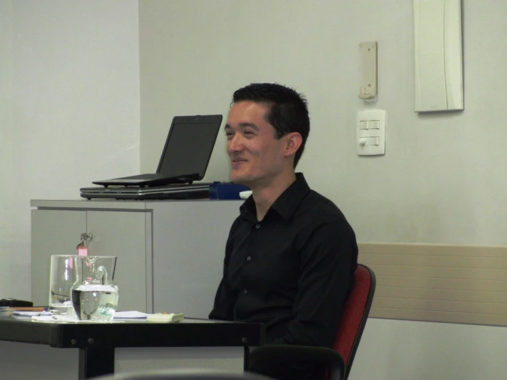 a man sitting at a table looking away from the camera