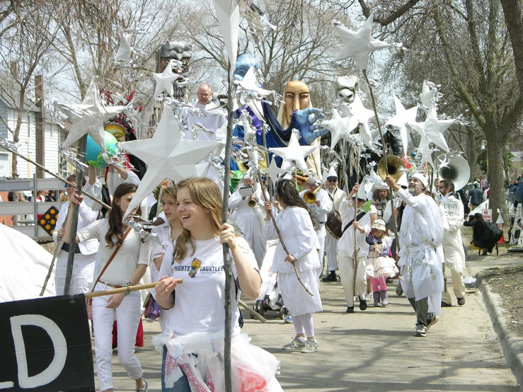 many people are in the street with paper machs on their head