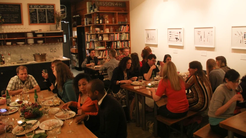 a group of people eating a meal inside a building