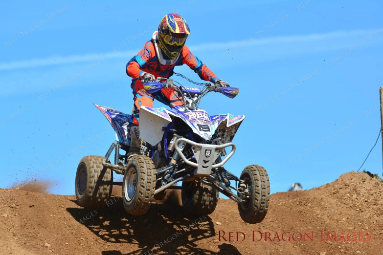 a person is riding an atv over dirt