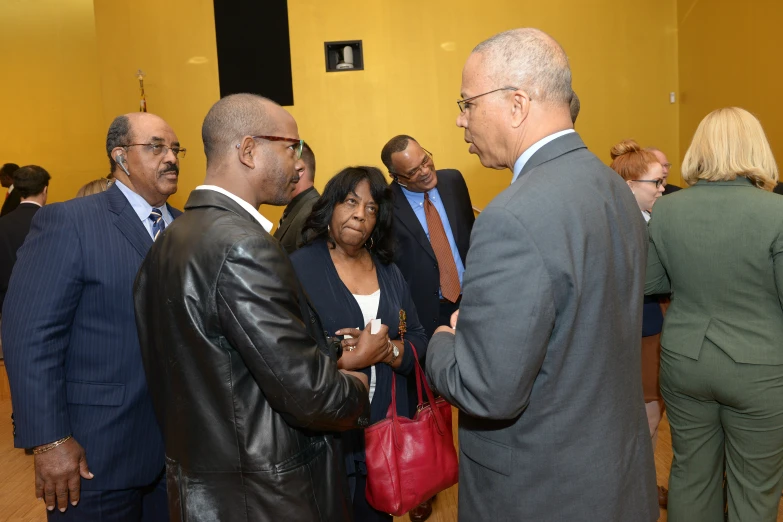 several business people meet around the lobby of a courthouse