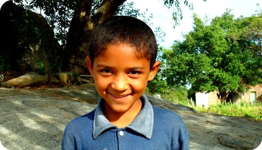 an image of a boy in the street smiling